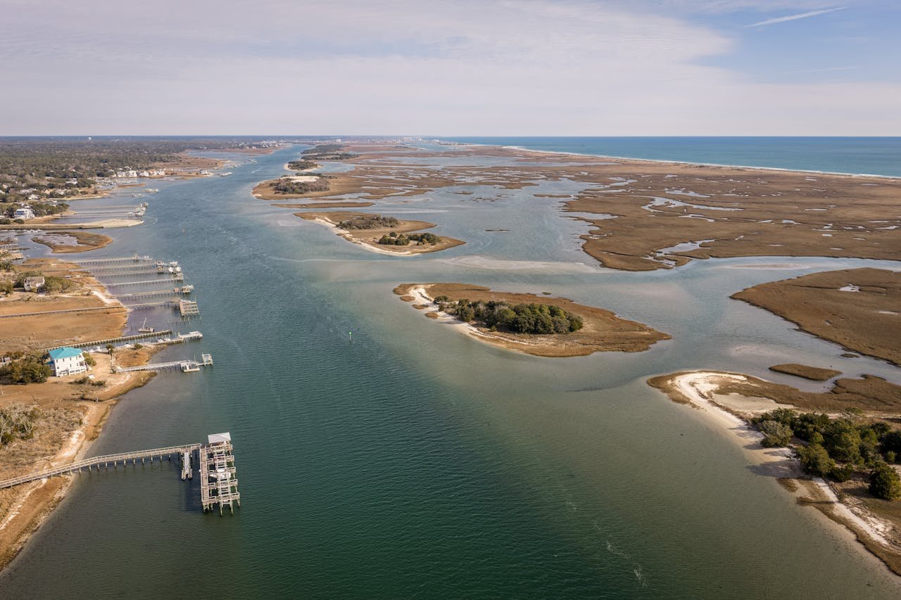 Aerial capture of serene waterway and marshlands near Wrightsville Beach, NC.